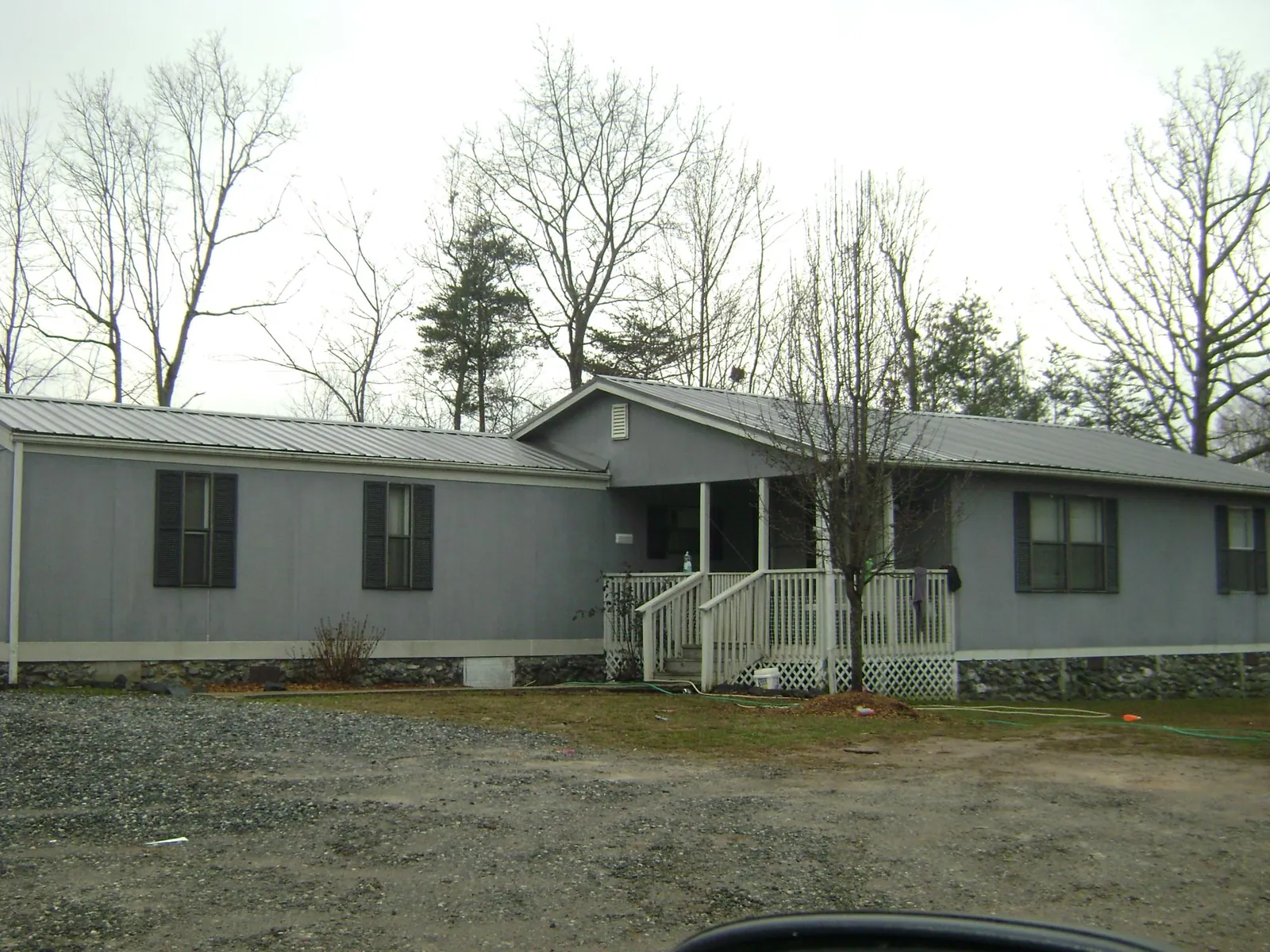 Metal roof over a manufactured home with a covered front porch in Freeburg